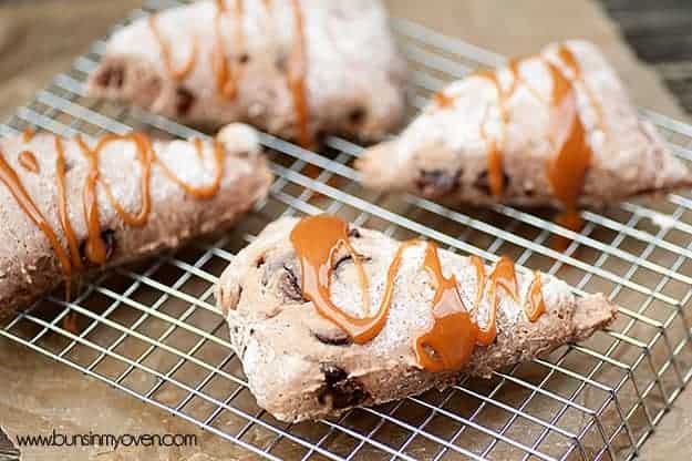 Four caramel glazed scones on a wire cooling rack.
