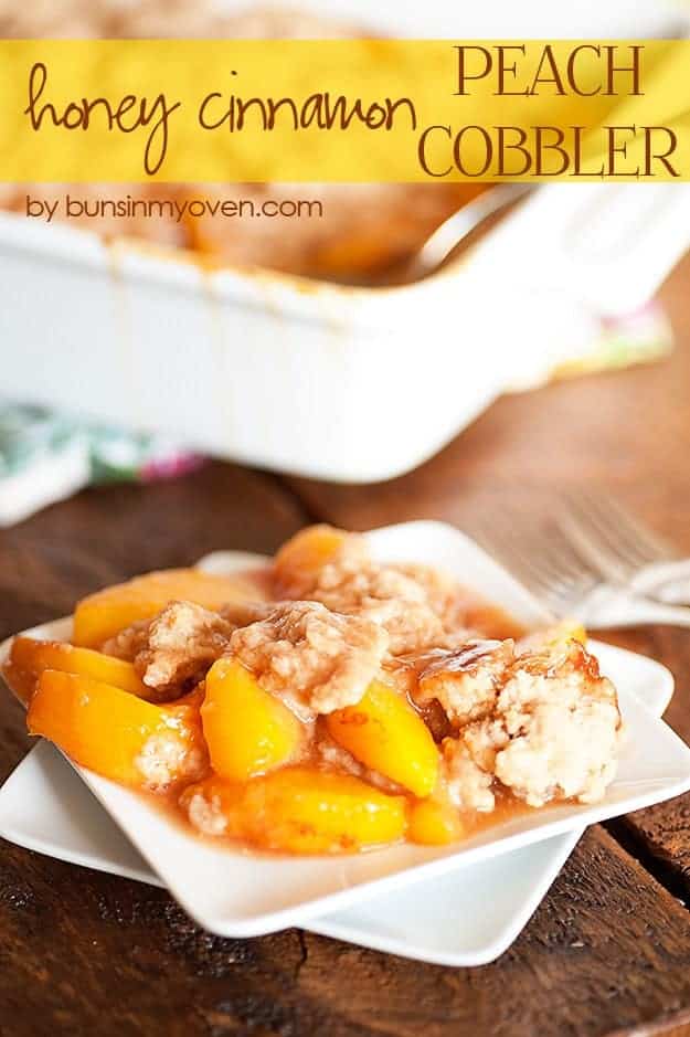 A close up of peach cobbler on a white plate.