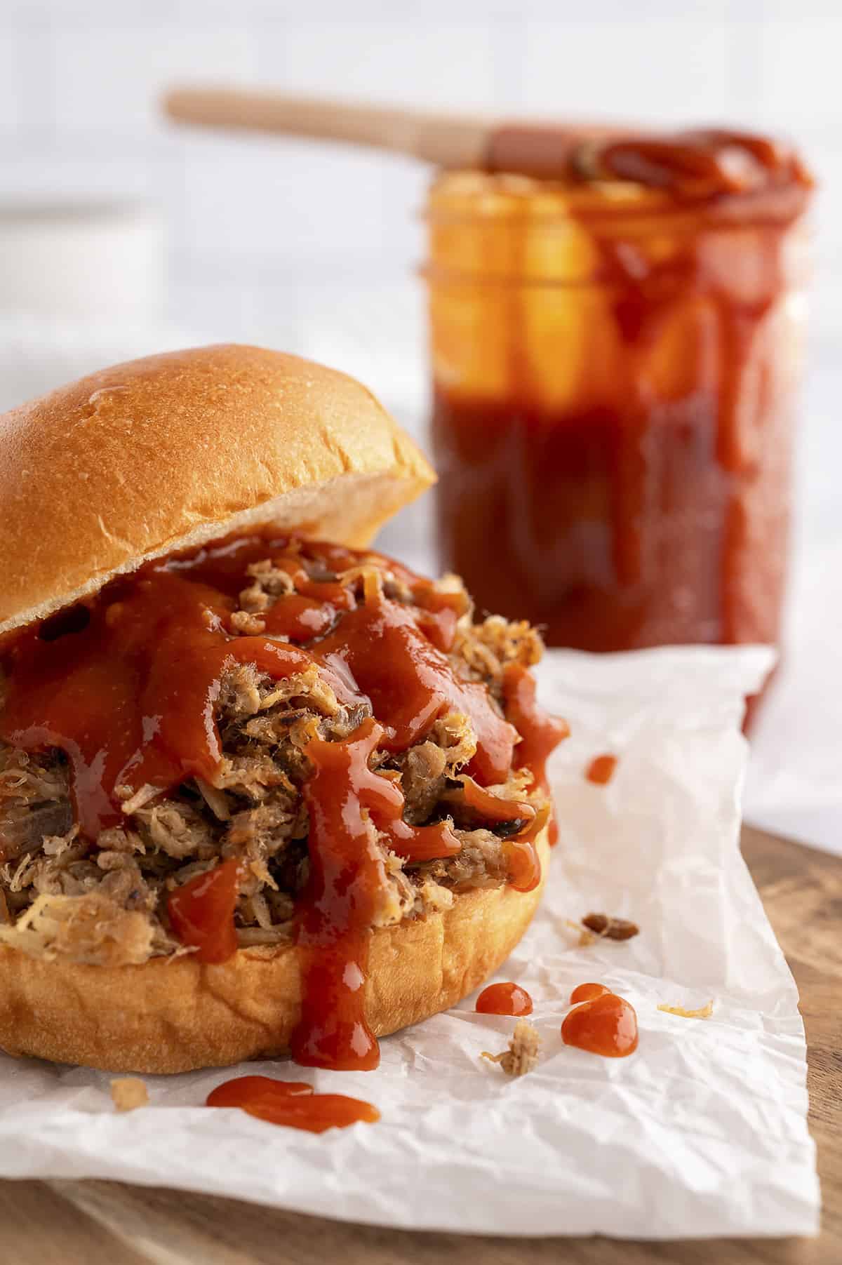 Tangy Carolina BBQ sauce drizzled over pulled pork sandwich.