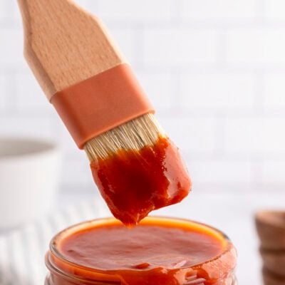 Carolina style BBQ sauce dripping off brush.