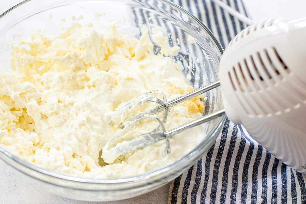 cream cheese mixture in glass mixing bowl.