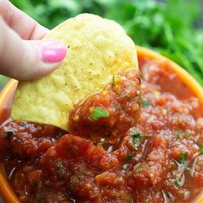 A chip dipped into salsa.