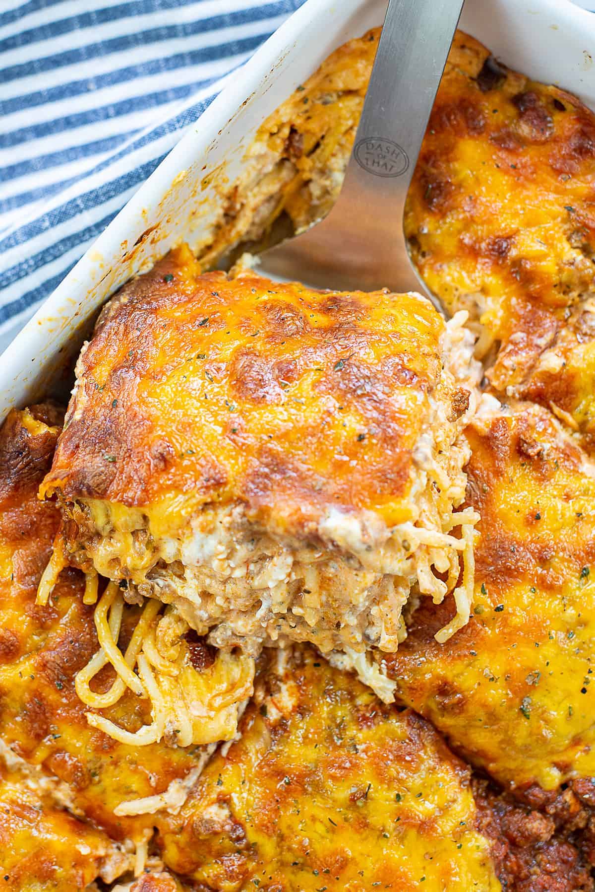 creamy baked spaghetti in baking dish.