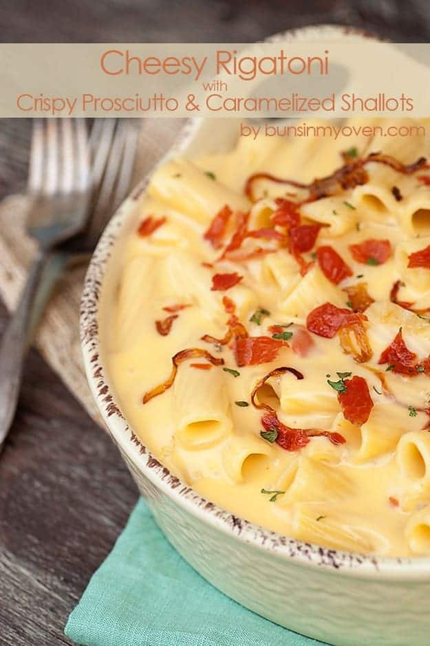 A bowl of rigatoni topped with caramelized shallots.