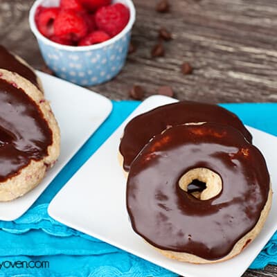 Two chocolate frosted donuts on a plate.