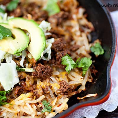 A cast iron skillet with taco filling in it.