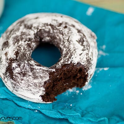 A chocolate donut With a bite taken out of it