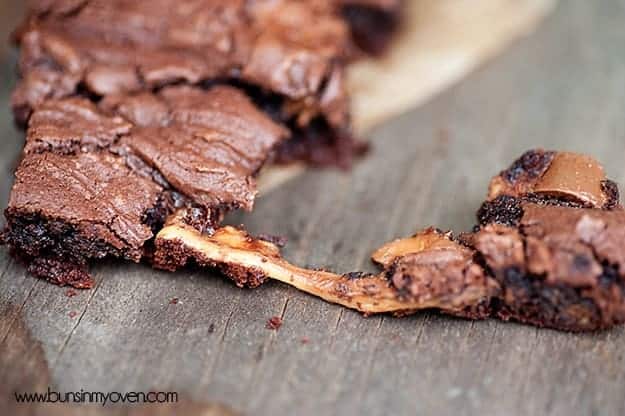 A string of caramel between two gooey chocolate bars 