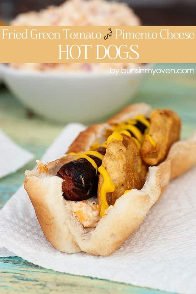 A closeup of a hot dog on a bun with fried green tomatoes 