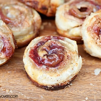 A handful of peanut butter and jelly pinwheels on a table.