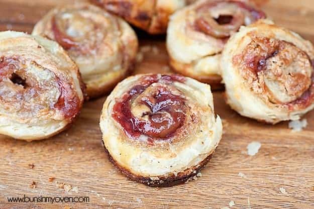 A handful of peanut butter and jelly pinwheels on a table.