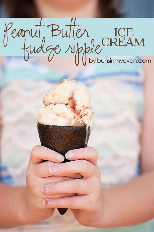 A person holding a peanut butter fudge ice cream cone 