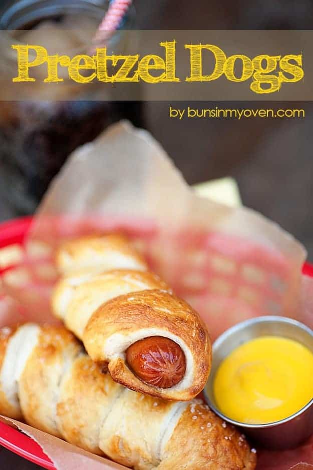 A closeup of a pretzel wrapped hot dog in an appetizer tray 