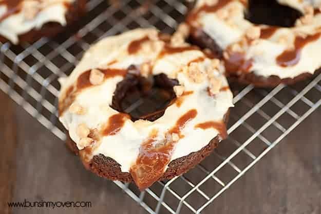 Two toffee doughnuts on a wire cooling rack 