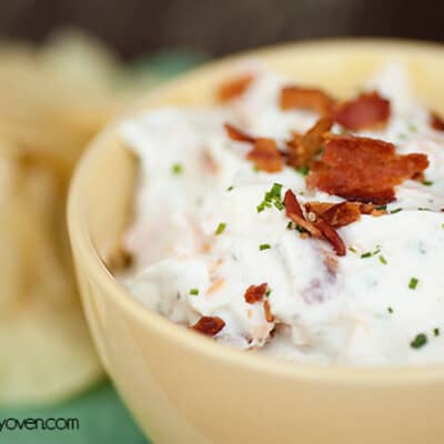 A close up of ranch dip in a glass bowl.