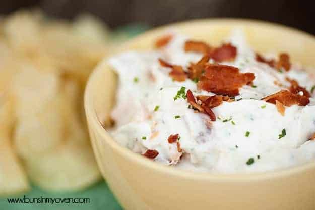 A close up of ranch dip in a glass bowl.