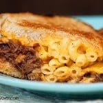 A close up of a plate of a macaroni and cheese sandwich.