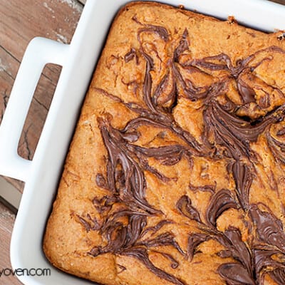 Overhead view of pumpkin nutella bars in a white baking pan.