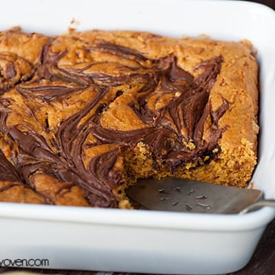 A white baking pan with cooked pumpkin bars in it.