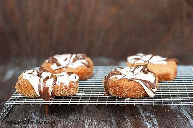 four smores doughnuts on a wire cooling rack.