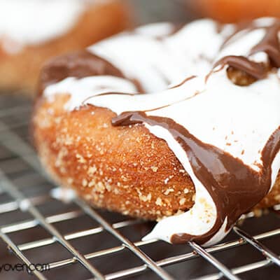 A close up of a donut topped with chocolate and marshmallow frosting.