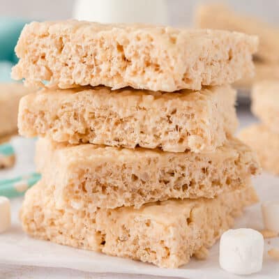 Rice krispie treats stacked up on counter.