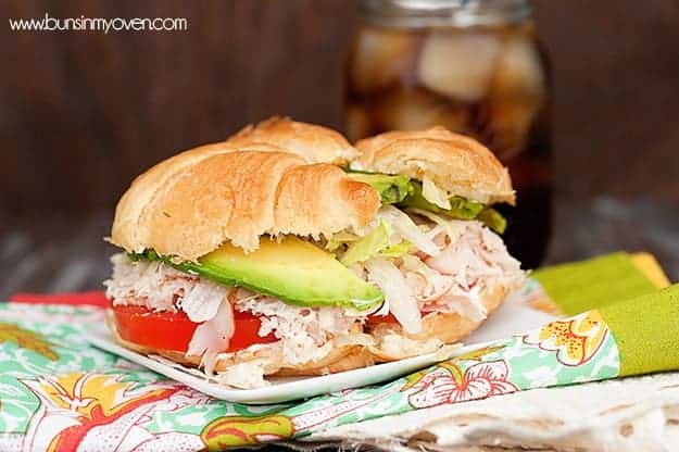 A close up of a sandwich sitting on top of a folded cloth napkin.