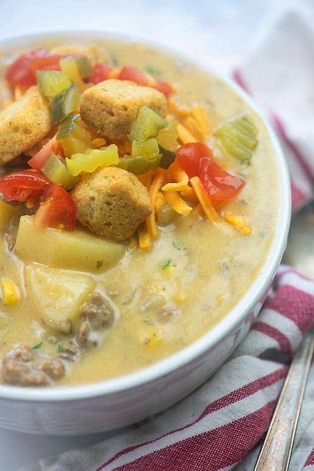 A close up of a bowl of cheesy soup.