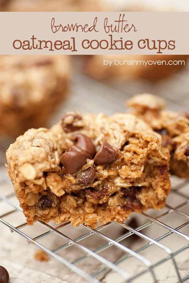 A close up of an oatmeal cookie split in half on a wire cooling rack.