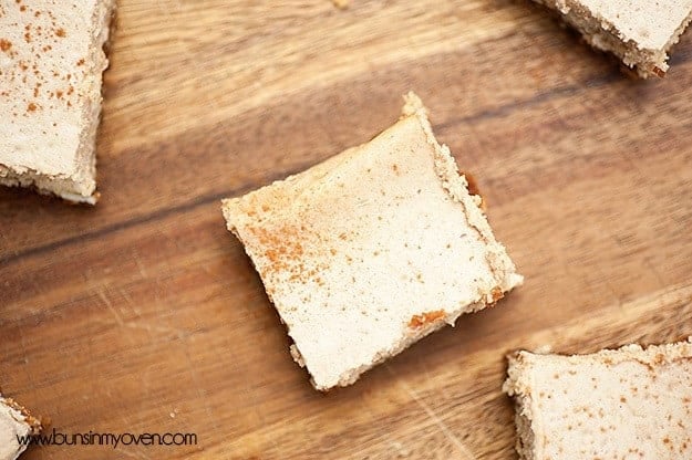 An overhead view of a cheesecake square on a cutting board.