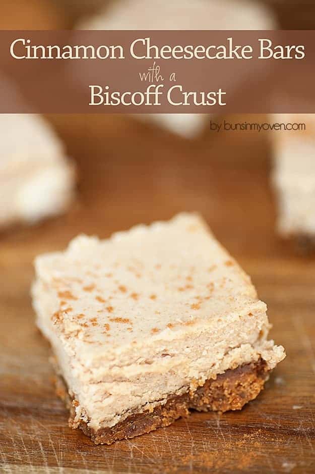 Several cinnamon cheesecake bars on a wooden cutting board.