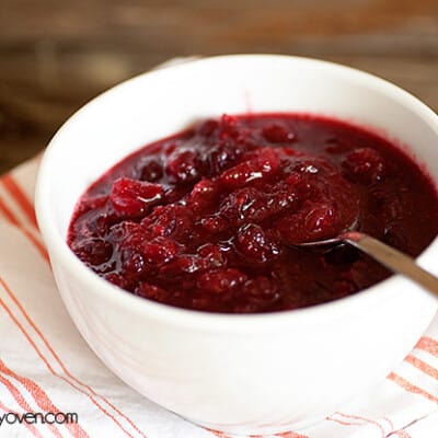 A bowl of cranberry sauce on a cloth napkin.