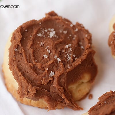 A close up of a shortbread cookie with chocolate icing