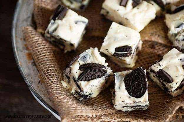 A close up of several pieces of Oreo fudge on a woven napkin.