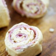 cut pinwheels on wooden cutting board.