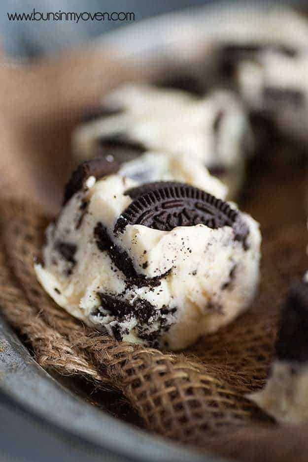 A close up of a cookies and cream fudge square with oreo chunks in it.