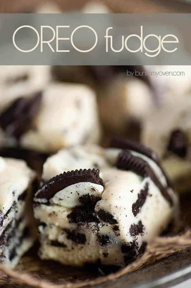 A close up of several white fudge squares with Oreo pieces in them.