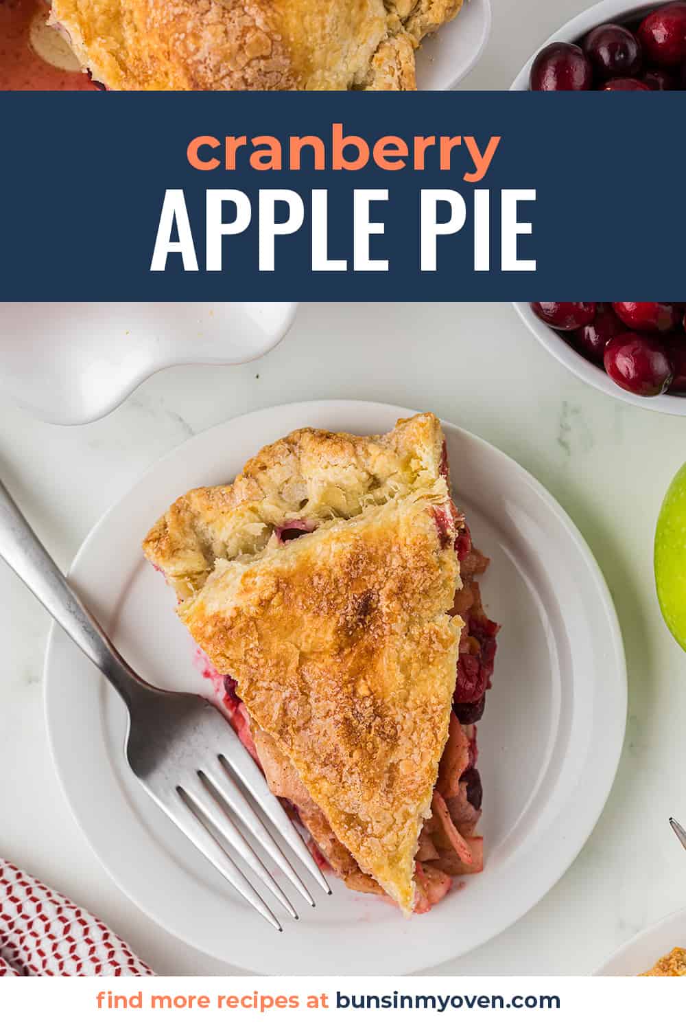 Overhead view of slice of apple cranberry pie on white plate.