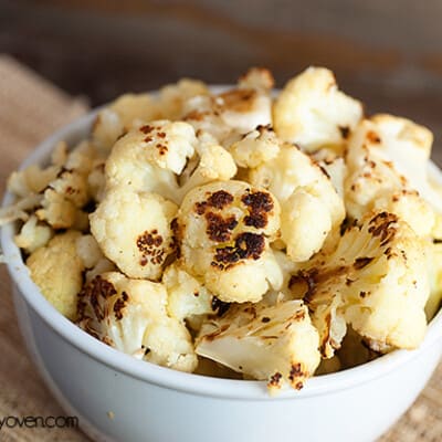 A bowl of roasted cauliflower in a white bowl.