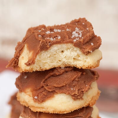 A stack of chocolate frosted shortbread cookies.