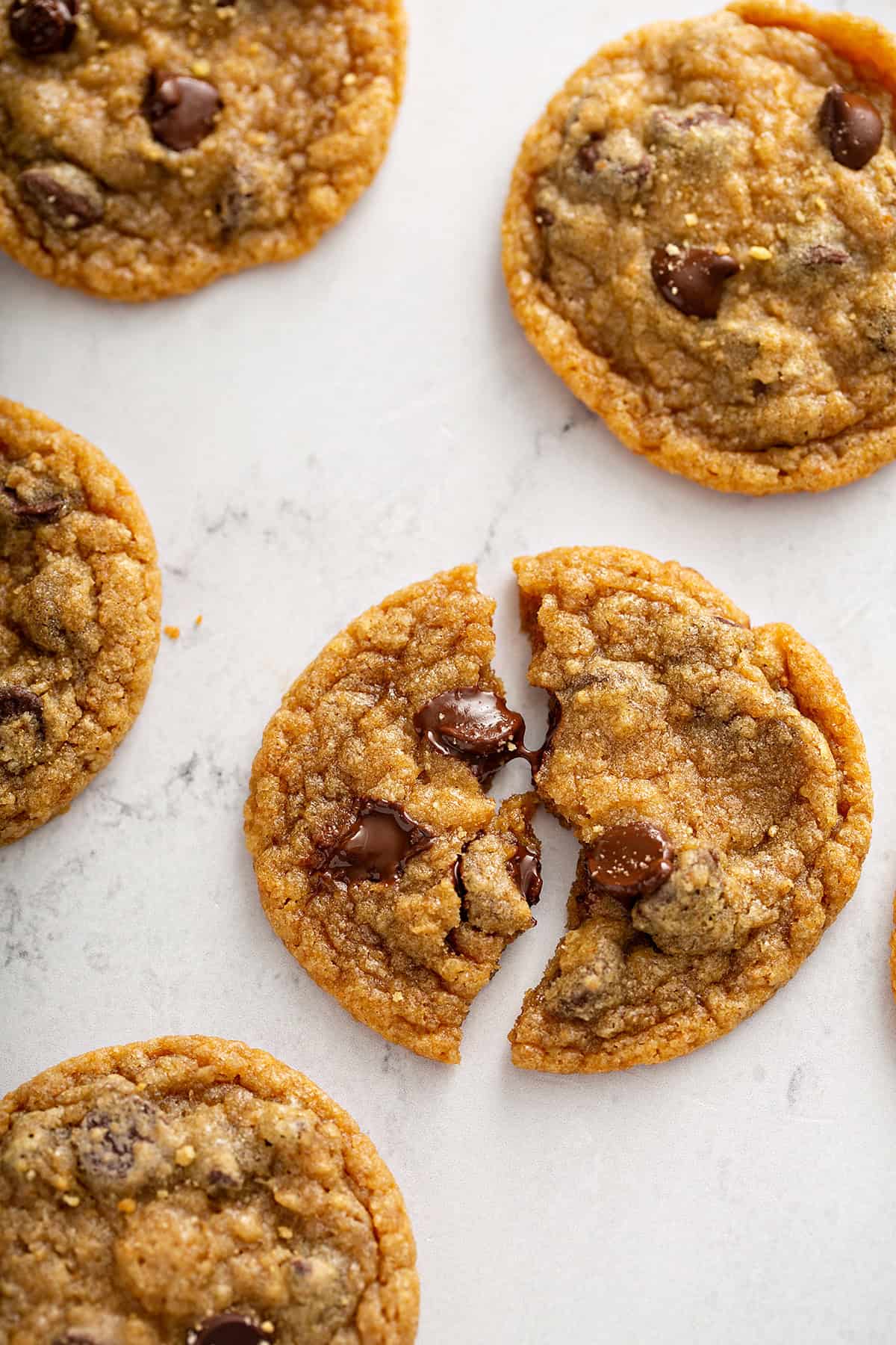 A close up of stacked up graham cracker chocolate chip cookies.