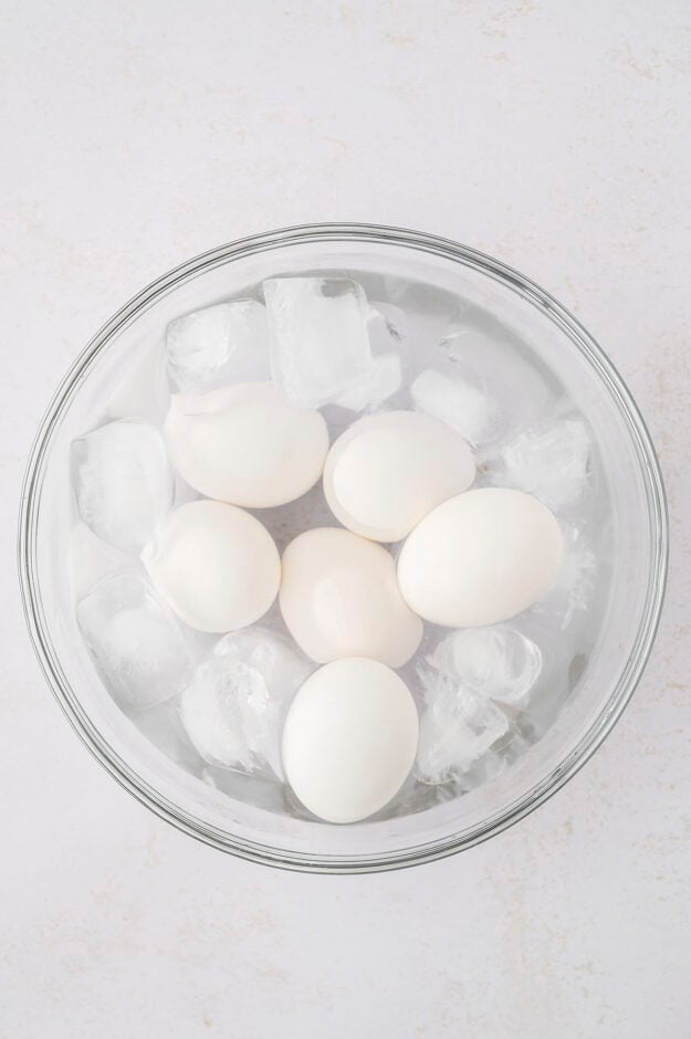 Boiled eggs in bowl of ice water.