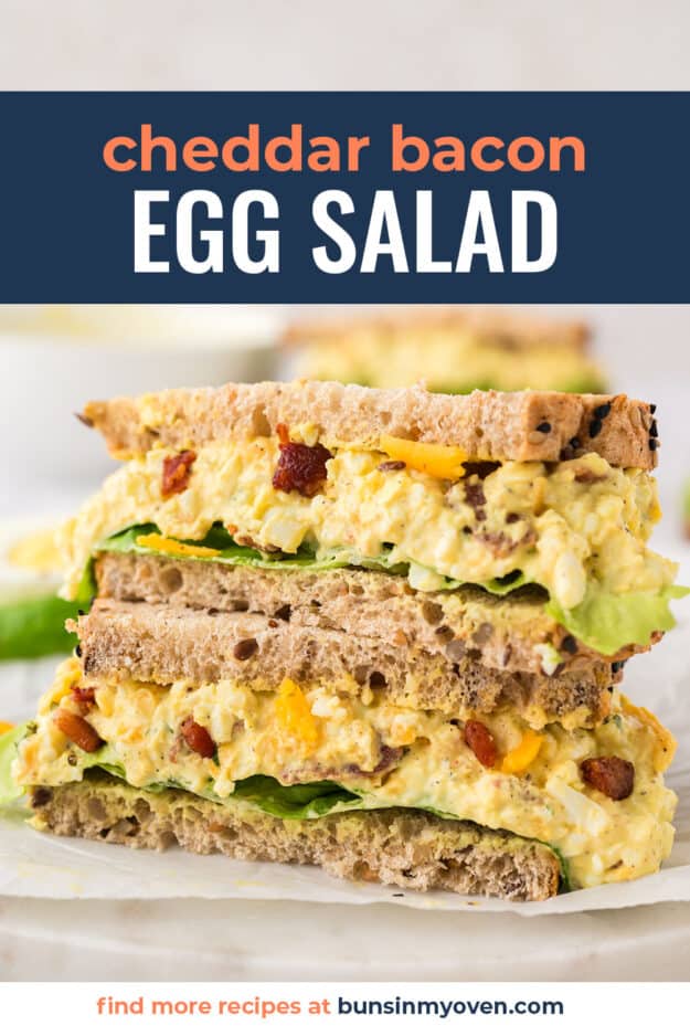 Egg salad sandwich sliced in half and stacked on top of itself with text for PInterest.