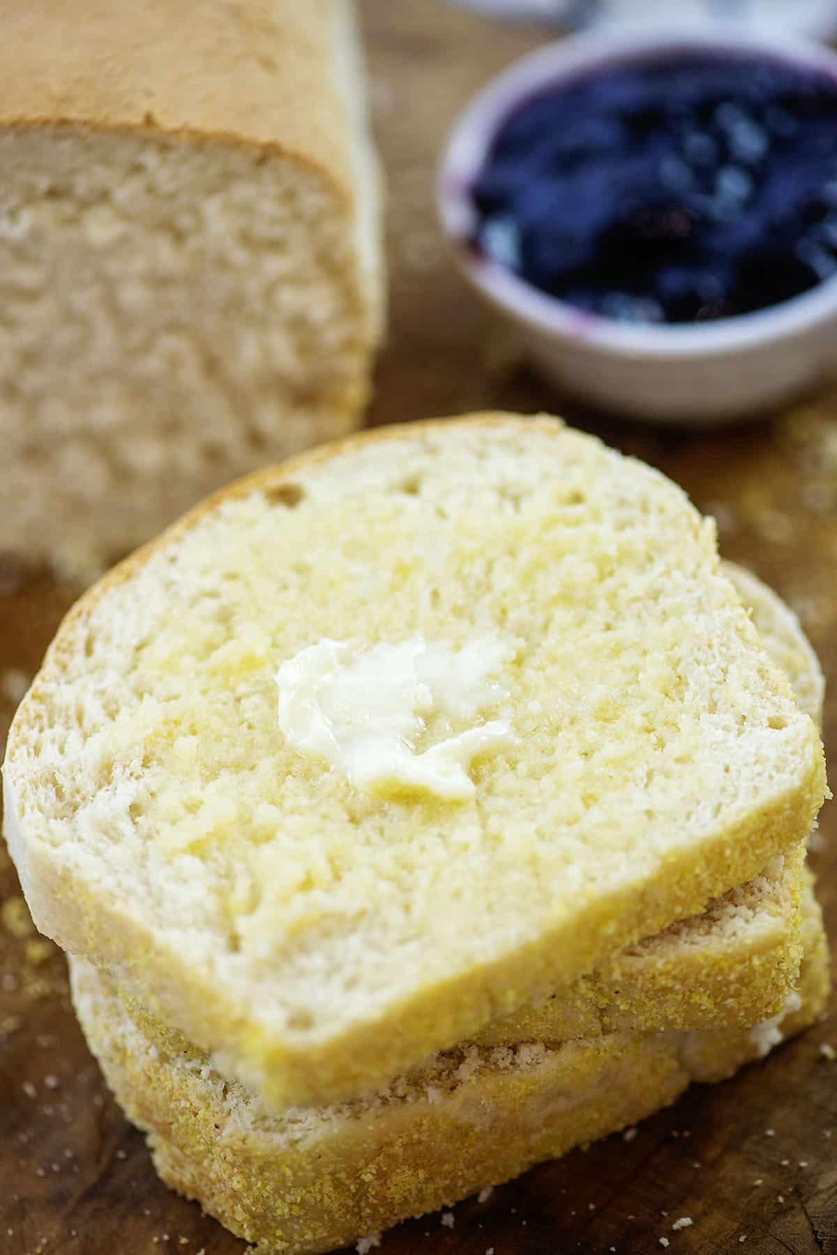 Sliced bread spread with butter.