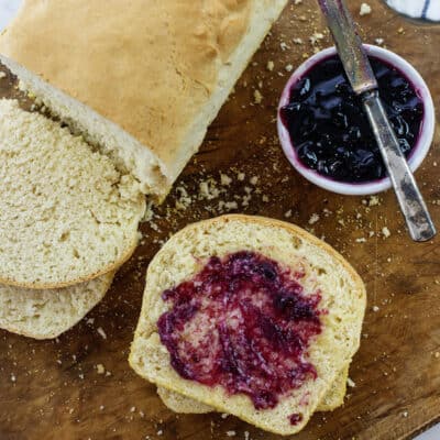 Sliced English muffin bread spread with jam.
