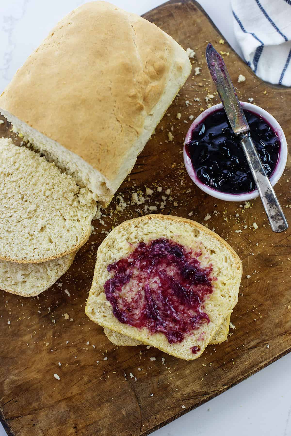 Sliced English muffin bread spread with jam.