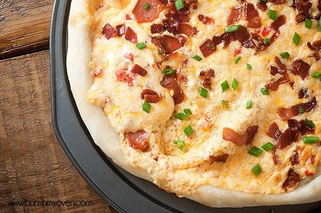 Overhead view of cheesy bacon pizza.