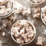 An overhead view of a few paper cups of puppy chow popcorn.