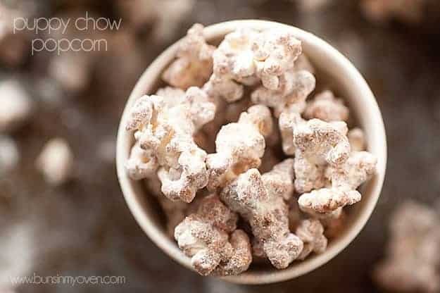 A close up of an overhead view of puppy chow popcorn in a cup.