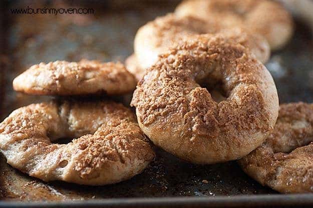 A close up of a stack of bagels topped with cinnamon